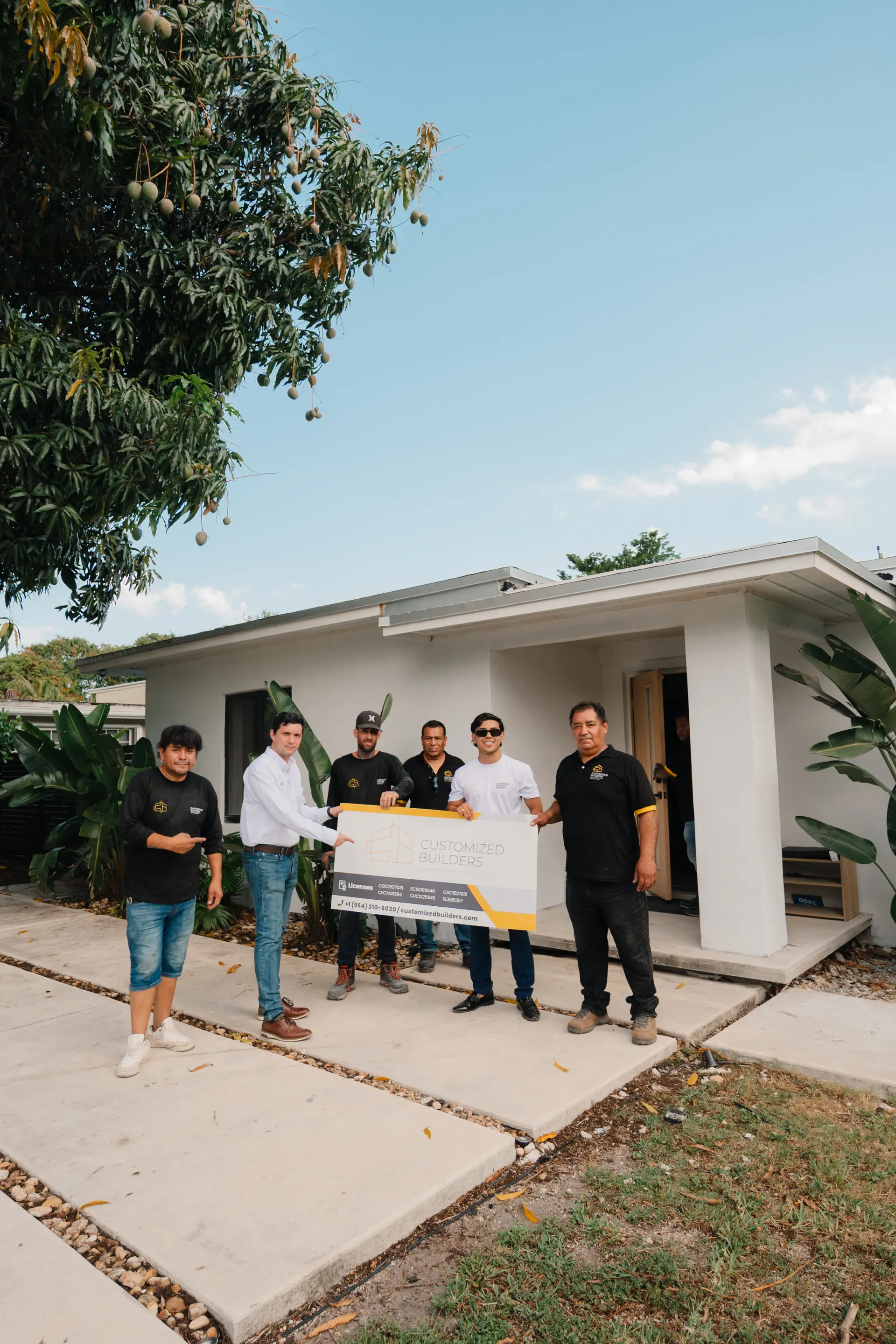 Customized Builders team presenting a completed home renovation in South Florida